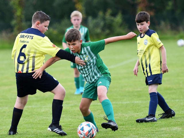 A midfield tussle from the under-10's match between Bonagee United and Sion Swifts Colts at Oakgrove.