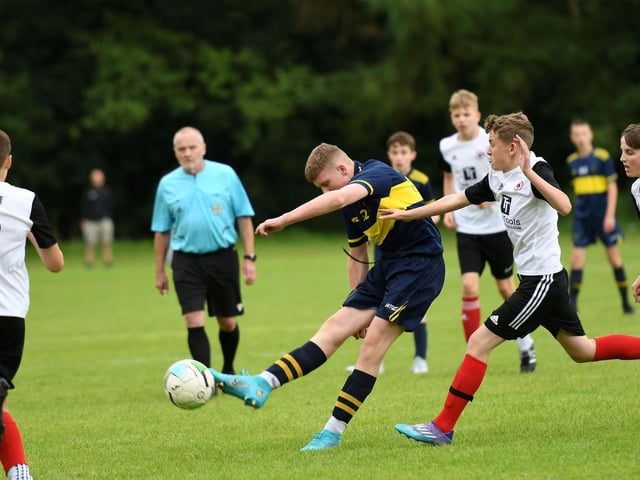 A Don Boscos under-14's striker unleashes a shot at goal during their match agaist Hillsborough Boys.