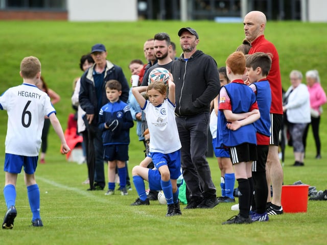 Kylie O'Donnell takes a throw-in for Quigley Point Swifts during their under-9's match against Maiden City Colts.