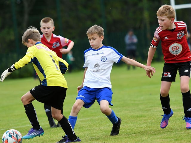 Maiden City Colts under-9's keeper' Kason Gardiner blocks this effort from Quigley's Point Swifts striker Harry Connolly.