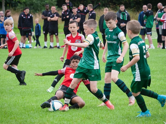 Foyle Harps tricky winger Kyle Downey attempts to evade the tackles of two Limavady defenders during Thurday's u-13 clash at Brooke Park, Derry.