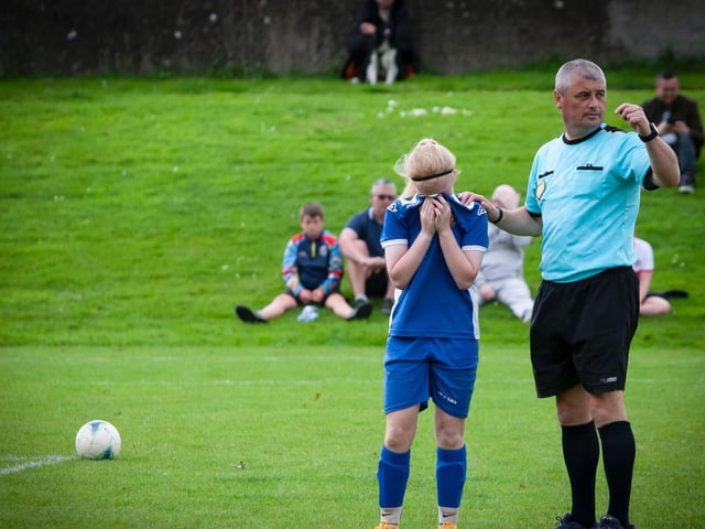 The game is momentarily called to a halt as this player receives treatement.