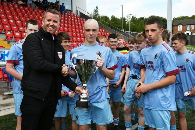 John Murphy from O'Neill's presenting the O'Neill's Foyle Cup Under-16's trophy to Institute captain Oisin Devlin at the Brandywell on Saturday. Picture by Keith Moore