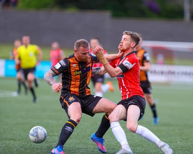 Dundalk's Mark Connolly stops Jamie McGonigle in his tracks during a recent match at Brandywell.