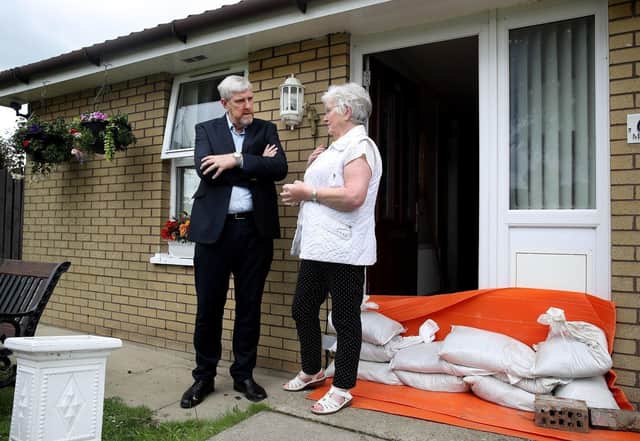 Infrastructure Minister John O’Dowd meeting a resident in Eglinton.