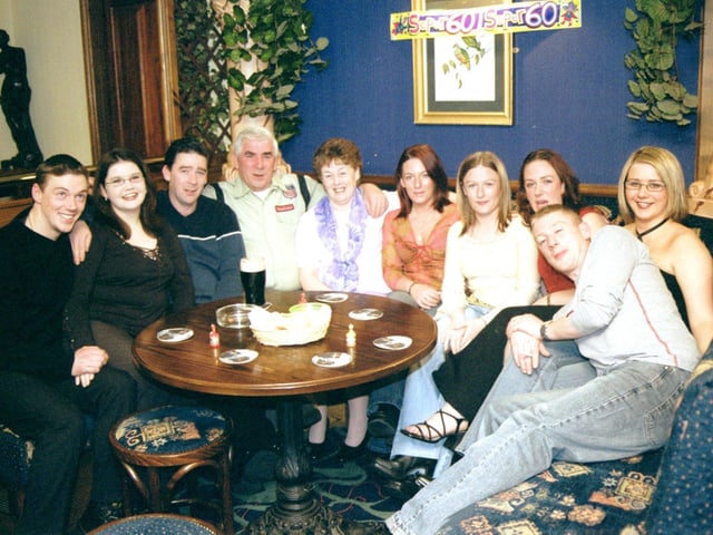 September 2002... Angela Cox celebrates her 60th borthday with husband, Jim, and members of her family circle.