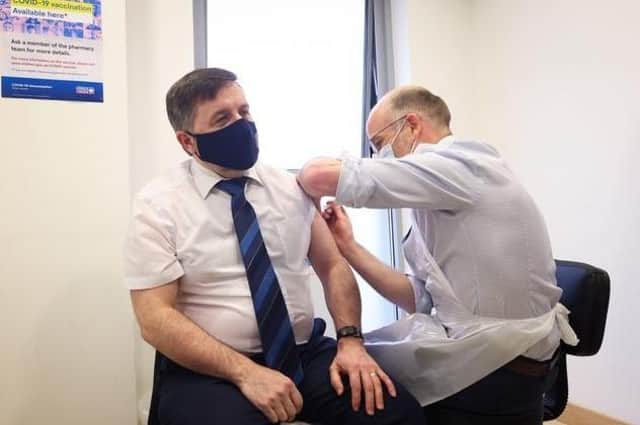 Health Minister Robin Swann receving one of his vaccines.
