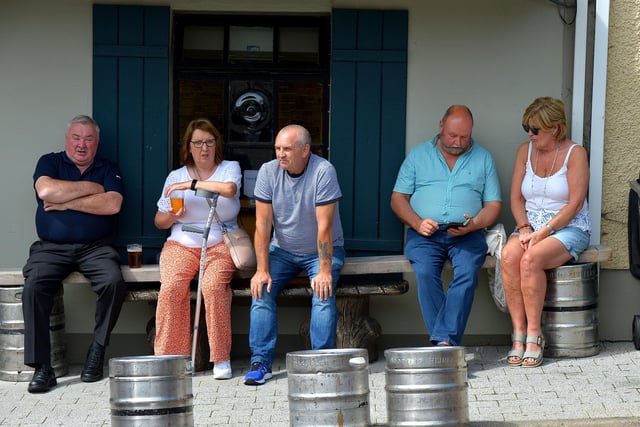 Spectators relaxing, in Market Square, during the Clonmany Festival Parade held on Sunday afternoon last. Photo: George Sweeney.  DER2231GS – 016