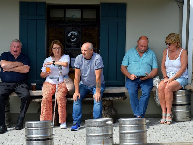 Spectators relaxing, in Market Square, during the Clonmany Festival Parade held on Sunday afternoon last. Photo: George Sweeney.  DER2231GS – 016