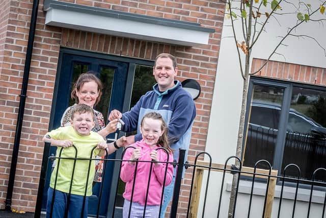 New Ard na Smoll resident, Carolanne O'Neill is pictured outside her new home with children Odhrán and Aoibheann and Marc McLaughlin from Apex