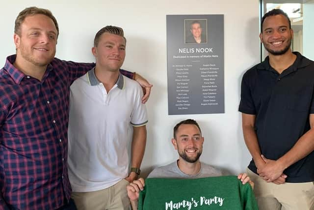 Martin’s son Aidan with friends at the plaque in memory of his father.