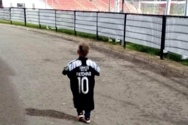 Proud as punch, four year-old Braelin walks into Brandywell wearing Will Patching's old jersey.