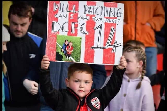 Young City fan Braelin tries to catch the attention of his hero Will Patching during a Derry City match at Brandywell