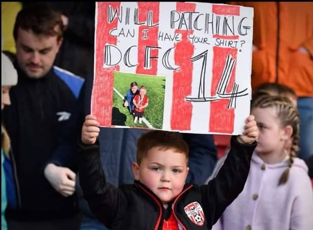 Young City fan Braelin tries to catch the attention of his hero Will Patching during a Derry City match at Brandywell