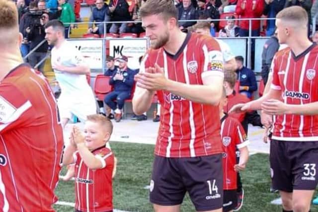 Braelin walks out onto the Brandywell pitch as mascot alongside his hero Will Patching for the recent home game against Drogheda.