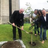Bishop of Derry Donal McKeown is joined by John and Pat Hume's children, Mo, Therese and Aidan, to plant a tree in their memory at St Eugene's Cathedral.