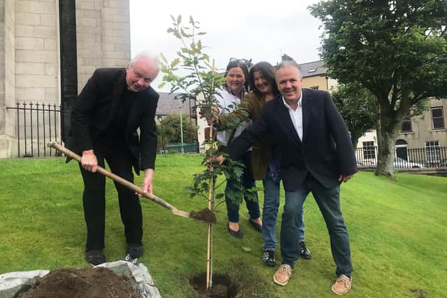 Bishop of Derry Donal McKeown is joined by John and Pat Hume's children, Mo, Therese and Aidan, to plant a tree in their memory at St Eugene's Cathedral.