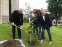 Bishop of Derry Donal McKeown is joined by John and Pat Hume's children, Mo, Therese and Aidan, to plant a tree in their memory at St Eugene's Cathedral.