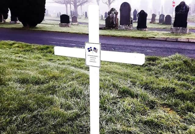 The white cross erected at Capt. Kokeritz's grave in December 2021.