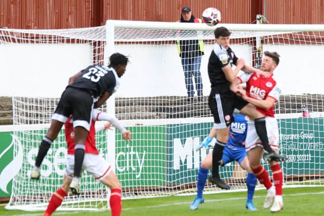 Danny Lupano sends a header wide of the mark early in the first half before his sending off on 33 minutes at Richmond Park. Picture by Kevin Moore.