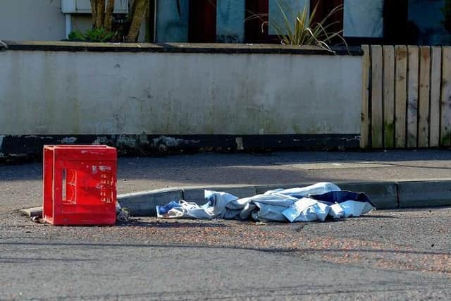 Rags and an empty milk crate that was used to carry petrol bombs after a night of disorder in Irish Street.