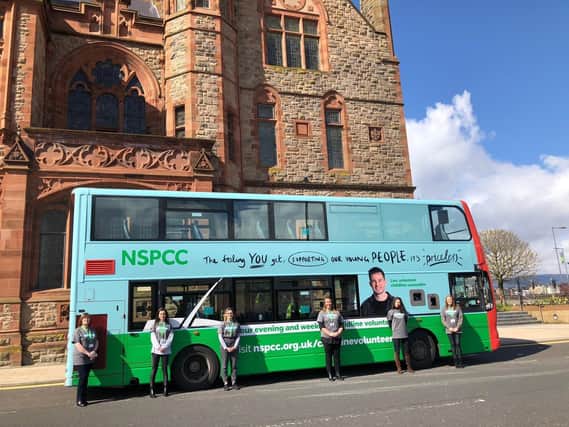 Childline volunteers pictured with a double decker bus servincing routes in the city which is calling for more volunteers.