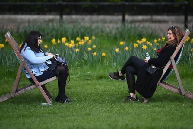 Two women sitting in deck chairs