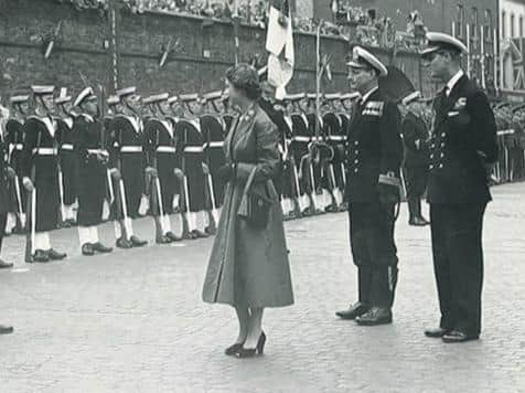 Prince Philip stands by with Elizabeth II of Great Britain and Northern Ireland in Guildhall Square in 1953.