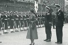 Prince Philip stands by with Elizabeth II of Great Britain and Northern Ireland in Guildhall Square in 1953.