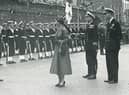 Prince Philip stands by with Elizabeth II of Great Britain and Northern Ireland in Guildhall Square in 1953.