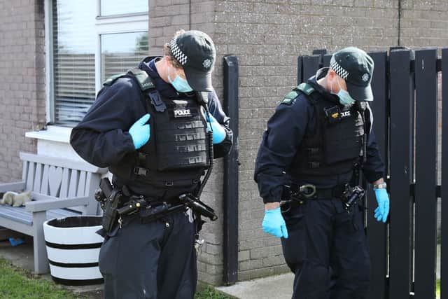 PSNI officers search the scene at last nights gun attack, Whitethorn Drive in Currynierin.  Picture by Lorcan Doherty /PressEye