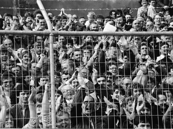 Derry City fans pack into the Brandywell Stadium to watch their hometown team play its first game in the League of Ireland against Home Farm in September 1985.