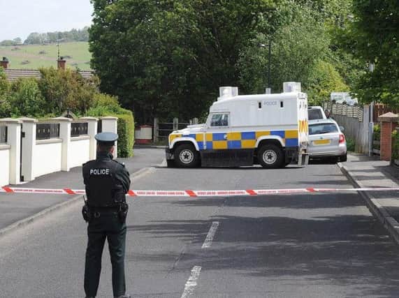 PSNI officers pictured at the scene in Eglinton after the home of a PSNI officer was targeted when a bomb was left under a car on June 18. 2015 DER2415MC056