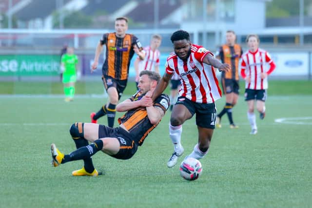 Dundalk's Andy Boyle attempts to drag James Akintunde to the ground during the first half at the Ryan McBride Brandywell Stadium. (Picture by Kevin Moore).