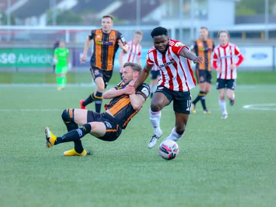 Dundalk's Andy Boyle attempts to drag James Akintunde to the ground during the first half at the Ryan McBride Brandywell Stadium. (Picture by Kevin Moore).