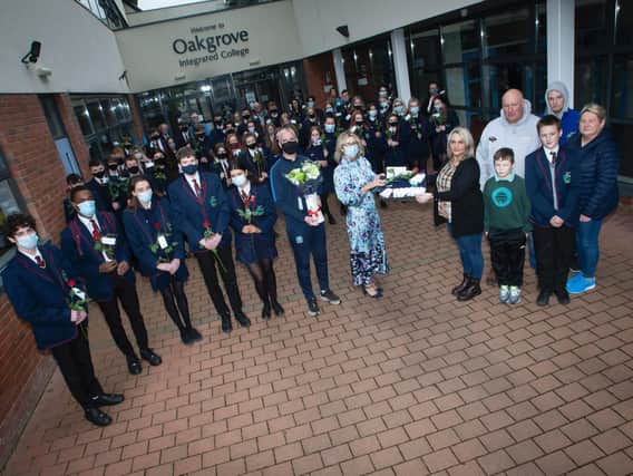Mrs Katrina Crilly (Principal) presenting Lee’s mum Jacqueline Gurney with Lee's Oakgrove Leavers Hoodie at Oakgrove Integrated College on Monday. Included are sixth form students and members of staff. On right also are Lee’s dad Derek, brothers Jay and Cain, and family friend Melanie Toland. (Photos: Jim McCafferty Photography)
