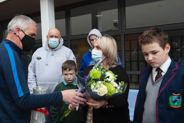 Mr Colin Donaghey (Year Head) presenting Jacqueline Gurney with a bouquet of flowers with reflections and messages attached during Monday’s event at the school to remember her late son Lee. (Photos: Jim McCafferty Photography)