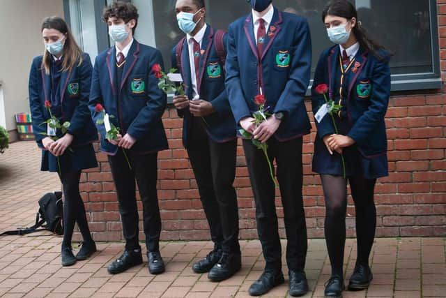 Friends Eva Wright, Sam Cole, Aajon Tench pictured during Monday’s tribute, with Head Boy Conor Brattin and Head Girl Emily Brown.