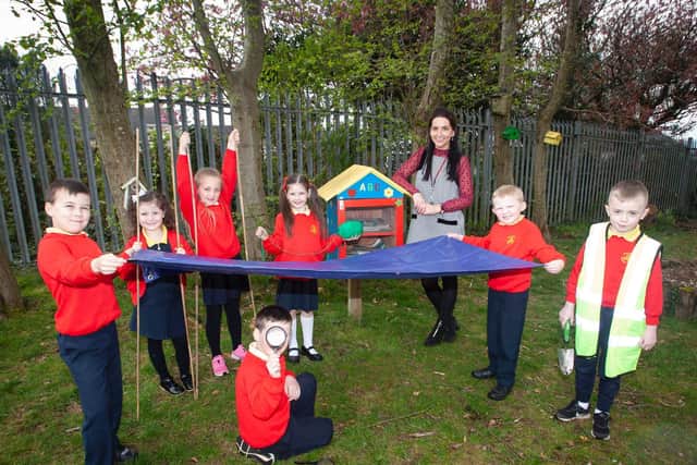 Steelstown PS teacher Miss Bronagh Lynch pictured with some of her class this week at the school Eco Garden where they have been learning outdoors as part of Forest Schools. Included from left are Matis McCarron, Faith Gillespie-McCloskey, Farrah Mooney, Niah Barnfield, Jacob McCollum, Jordan Starrs and Ronan Stewart.