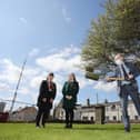 Education Minister Peter Weir visiting Limavady Shared Education Campus to cut the first sod on the new £11 million scheme. Looking on are students  Leah Craig and Clara Clements.