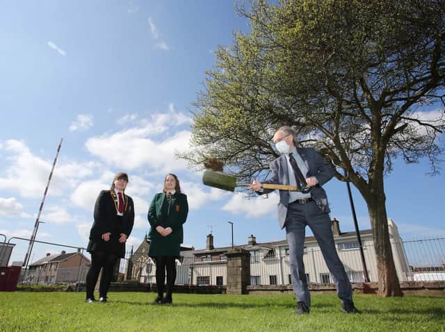 Education Minister Peter Weir visiting Limavady Shared Education Campus to cut the first sod on the new £11 million scheme. Looking on are students Leah Craig and Clara Clements.