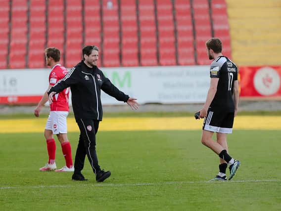 Derry City boss Ruaidhri Higgins is all smiles as he greets matchwinner Will Patching at the final whistle. (Picture by Kevin Moore).