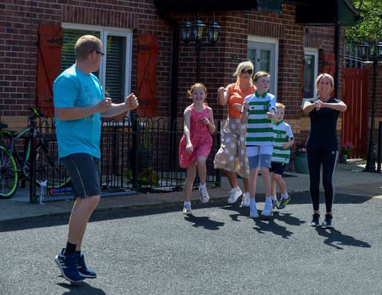 Families from Old City Close take part in Street Exercises, facilitated by the Brandywell and Bogside Health Forum, on Wednesday afternoon last. DER2220GS - 001