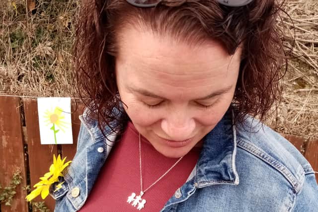 Geraldine shows a pin that was given to Amelia's classmates, which poignantly features a sunflower.