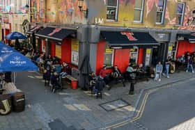 Customers enjoy the sunshine and a drink over the Bank Holiday weekend as lockdown restrictions were further eased on Friday last. Photo: George Sweeney / Derry Journal.  DER2117GS - 052