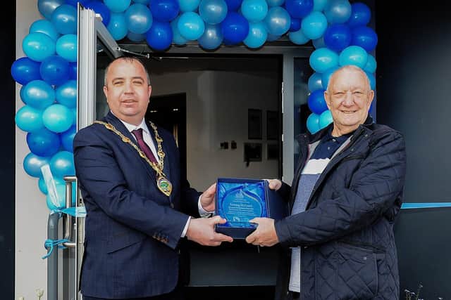 The Mayor of Derry and Strabane Colr. Brian Tierney presents a gift to Tommy McCout, Manager of Rosemount Resource Centre,yesterday afternoon to mark his retirement after serving the community for over 30 years. Photos: George Sweeney / Derry Journal. DER2118GS – 019