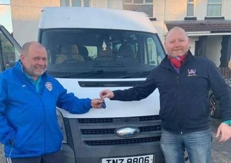 Stan Falconer handing over the keys to the minibus to Jason Hughes from NICC.