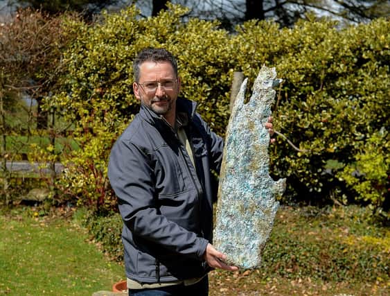 Jonny McNee holds a part of a propeller, recovered from the WWII Bristol Beaufort twin-engine torpedo bomber crash site at Ballykelly. DER2118GS – 002