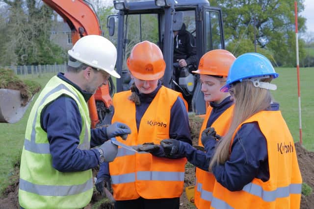 Jonny McNee and members of the Foyle College Aviation Team during the dig examining items they have found.