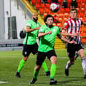 Finn Harps midfielder Barry McNamee keeps his eye on the ball as Derry City’s Ronan Boyce prepares to tackle during Monday night’s derby. Picture by Kevin Moore/MCI